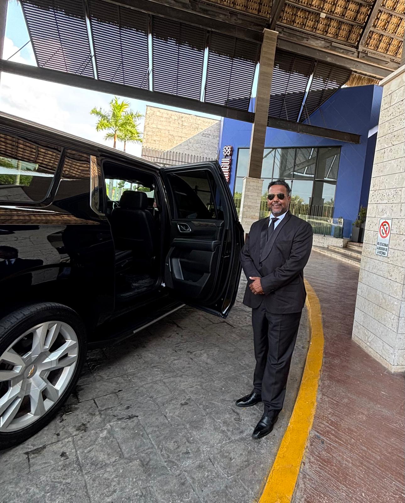 Driver holding the door open for a guest